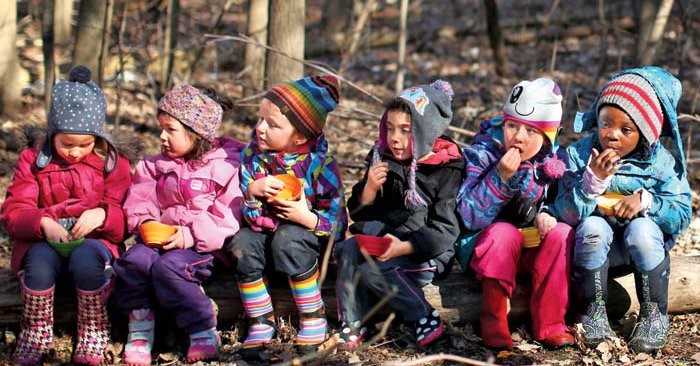 Kids outside on a log