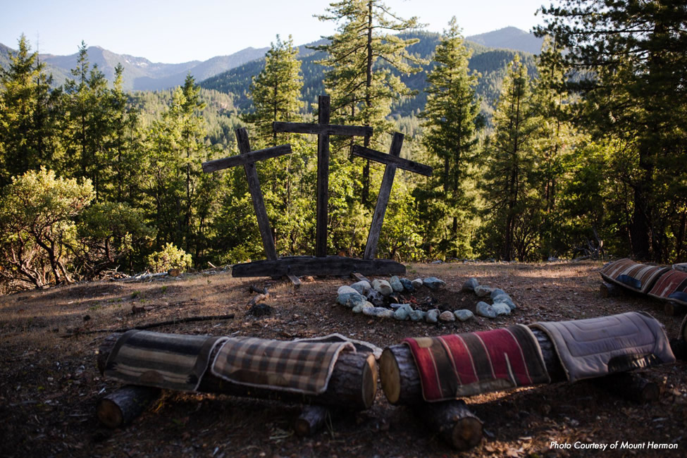 campfire with three crosses in the background